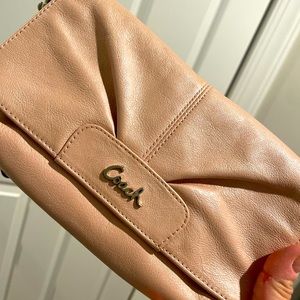 Shimmery, pearlescent Coach wristlet with strap. Perfect for day or night.